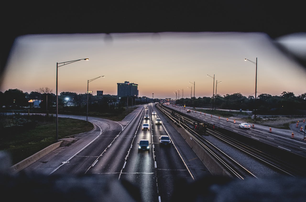 Cars travel on a Chicago highway during twilight, capturing the urban evening vibe.